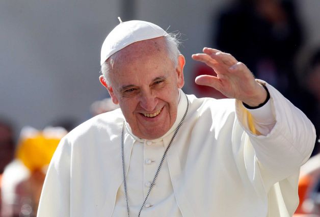 Pope Francis waves to faithful in St. Peter's Square at the Vatican, Sept. 18, 2013.