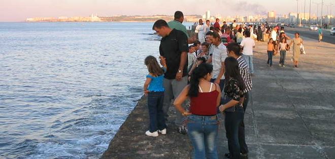 Cubans gather to watch sunset at the ocean