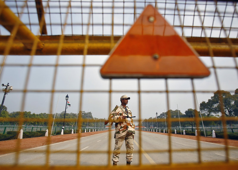 An Indian security personnel stands guard near India Gate ahead of the Republic Day Parade in New Delhi on Saturday. President Obama will attend the parade on Monday.